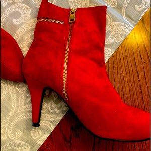 Hot red suede booties with gold zippers.